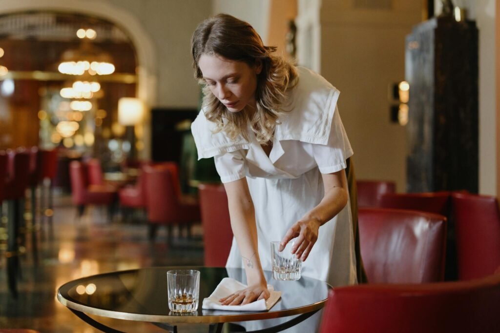 Woman in White Dress Wiping Table